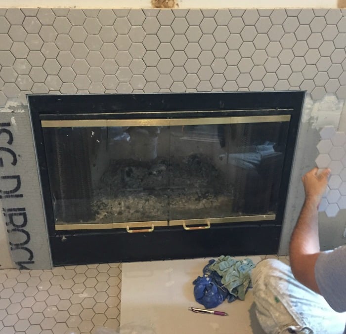 adding gray hexagon tile to fireplace surround