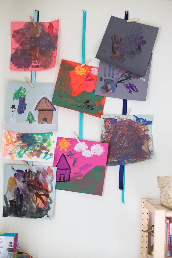 Kids artwork as decor - using ribbons to hang kids artwork.