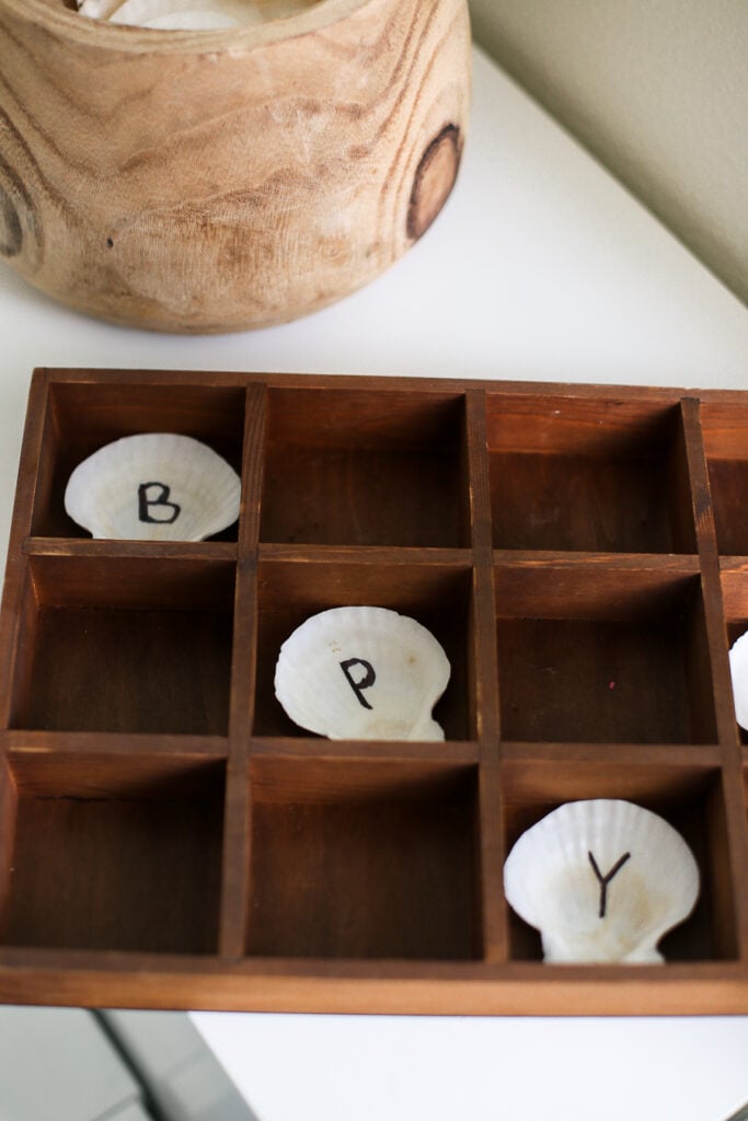 Seashells are learning tools in a wood caddy in kids playroom