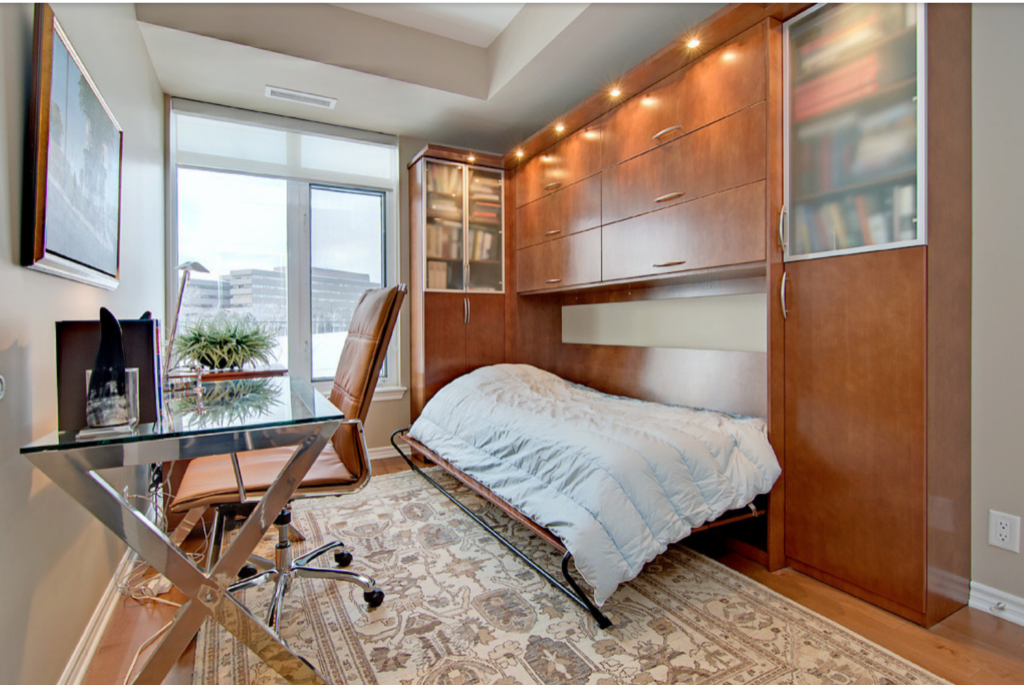 wood hideaway bed in a home office and guest room combined