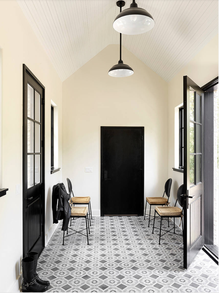 Black mudroom door with black hardware.