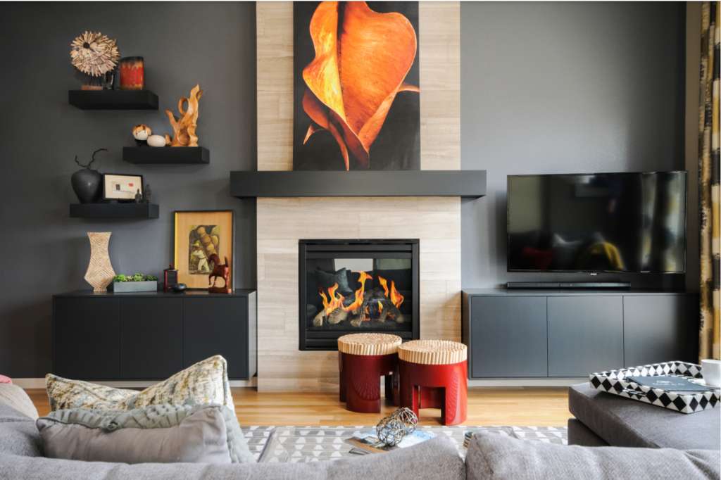 Large chunky wood floating shelves in a dark living room with a firplace.