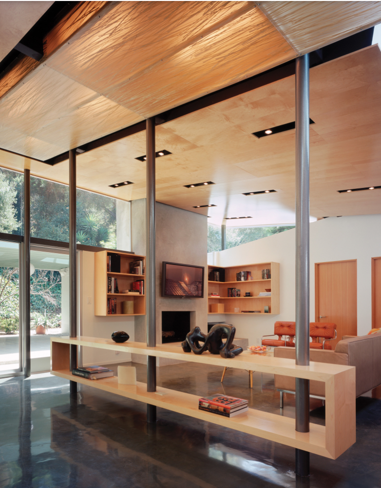 Bookshelves mounted on either side of a fireplace. the room contains a lot of wood furniture and metal decor pieces.