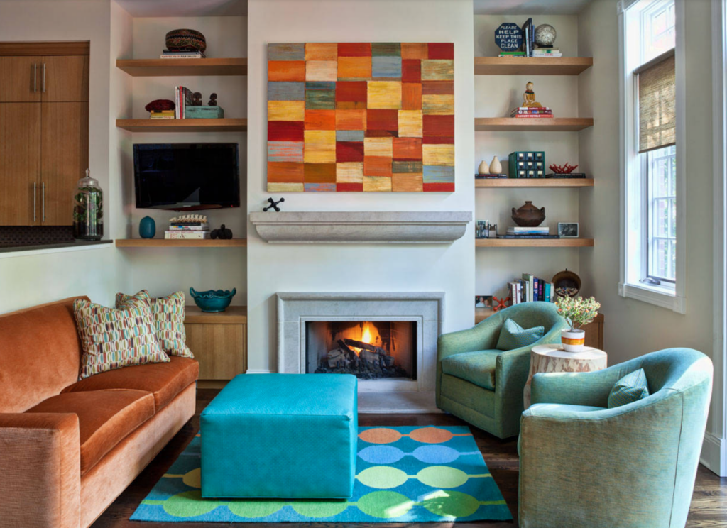 Large art work over hangs this firepalce that also has floating shelves on either side.
