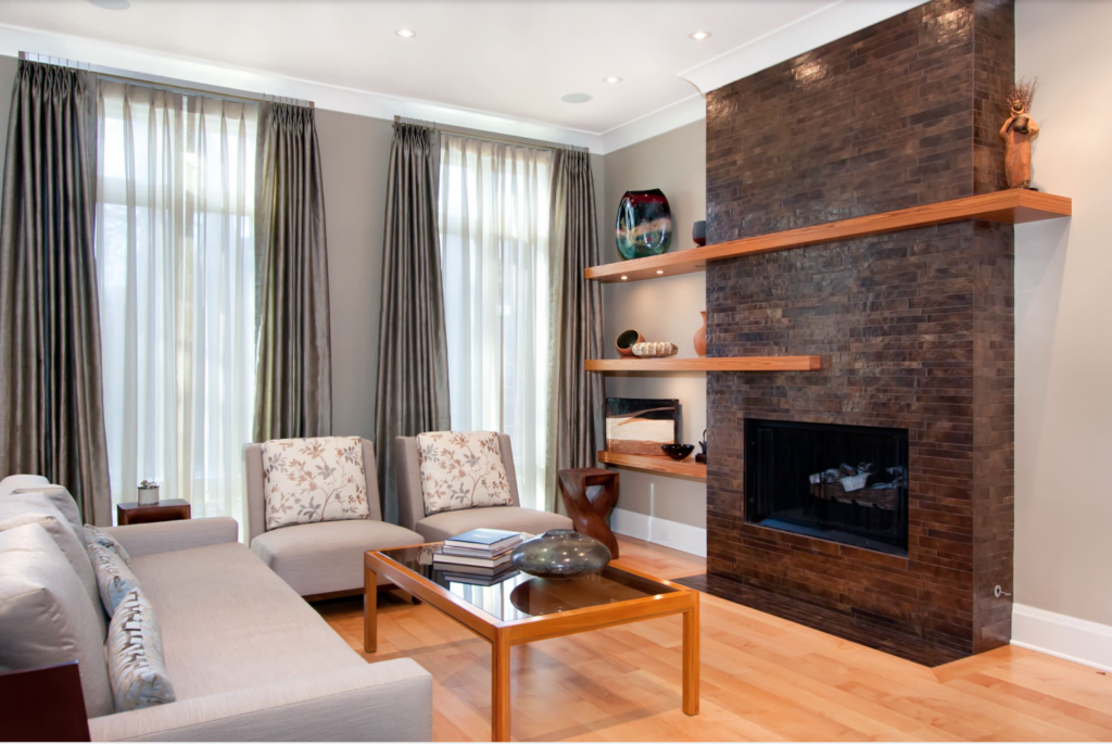 Floating shelves act as a fireplace mantle and provide extra storage in this simple living room.