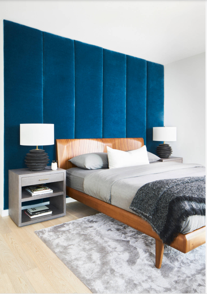 Plush fabric covering a wall in a small bedroom.