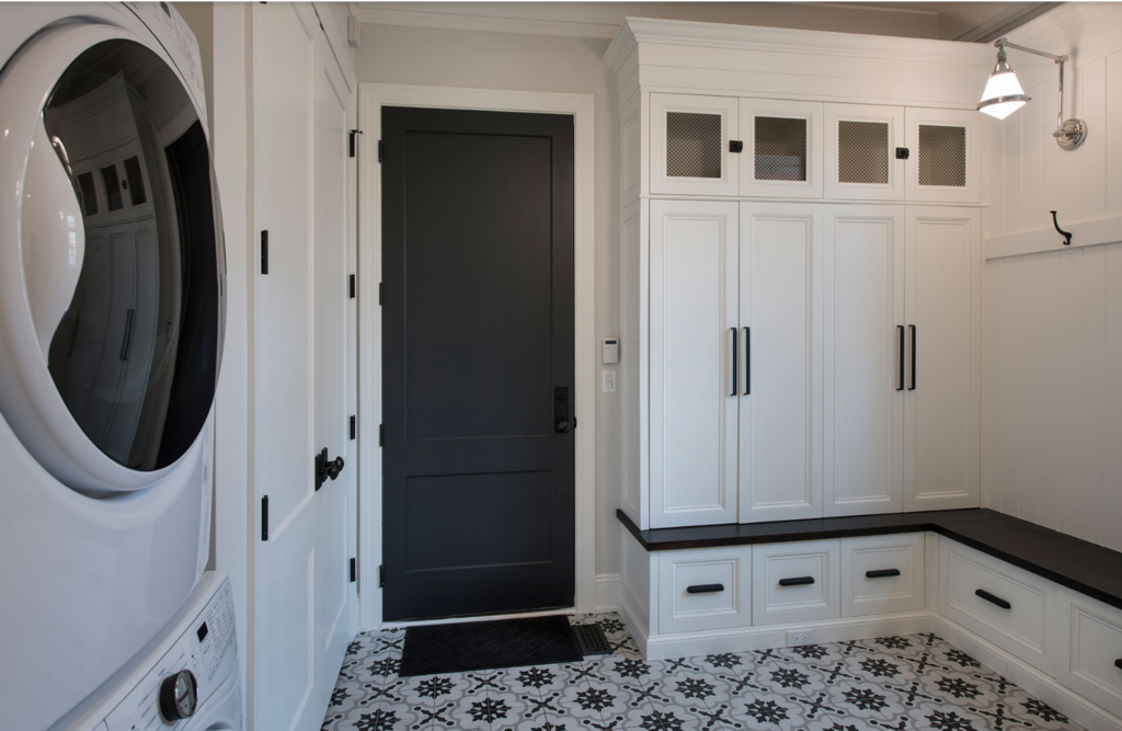 Tricon black painter interior door in a space with mostly white room with black and white tiles.