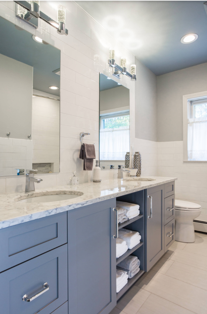 Blue gray painted bathroom cabinet in this coastal themed bathroom.