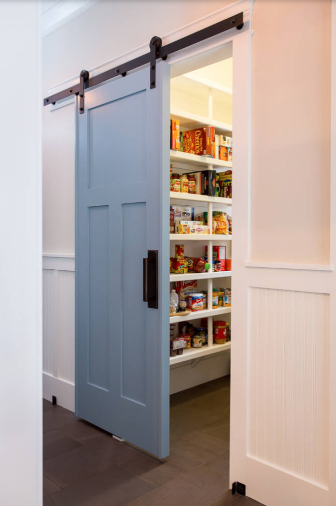 Valspar silver fox painted interior barn door leading to a pantry with black hardware.