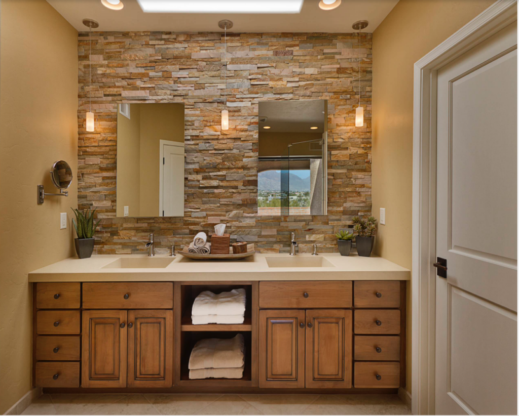 Medium colored wood used for this bathroom cabinet. The space has a stone backsplash and beige painted walls.
