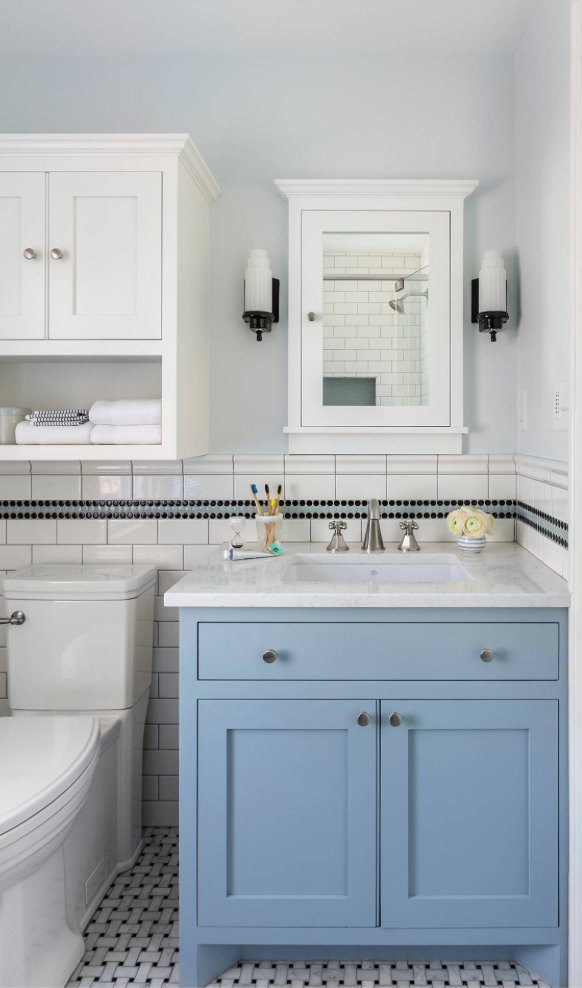 Powder blue bathroom cabinet in this small bathroom.