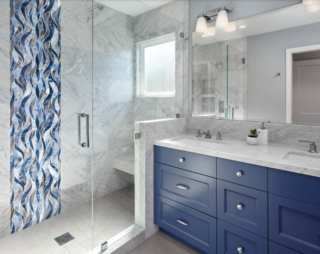 Bathroom cabinet painted in royal blue. The space also has blue walls and a blue shower curtain to coordinate.